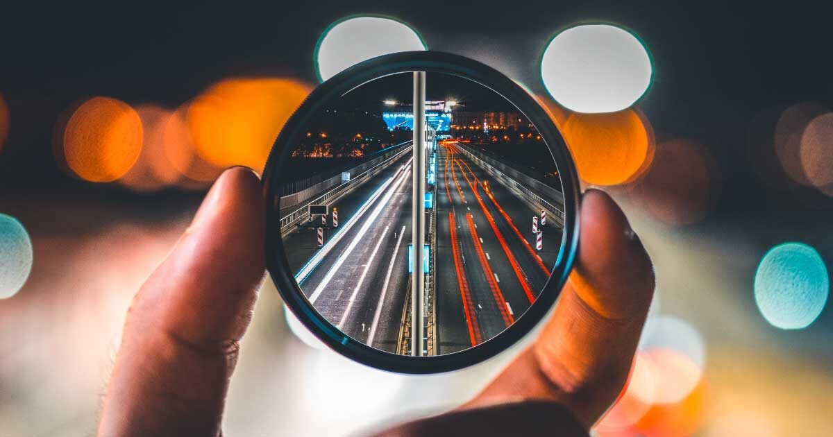 Focused marketing efforts for maximum impact. A lens zooms in on a highway, symbolizing clarity and targeted strategies in marketing.