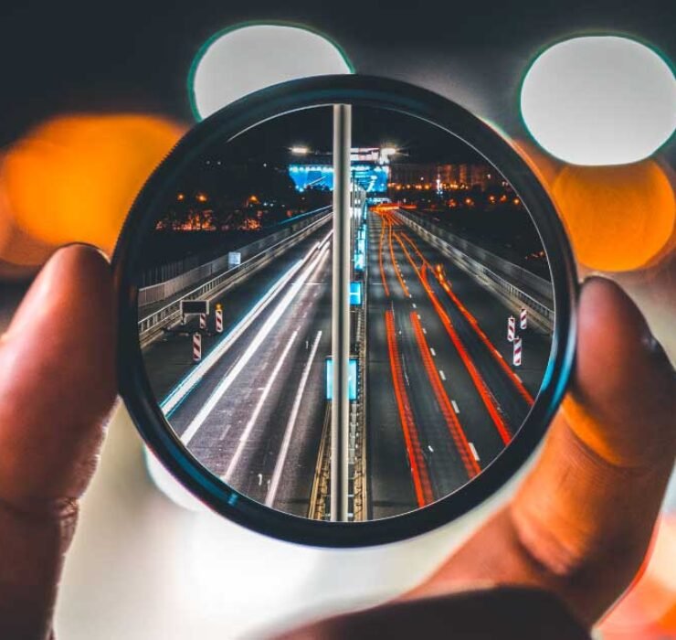 Focused marketing efforts for maximum impact. A lens zooms in on a highway, symbolizing clarity and targeted strategies in marketing.